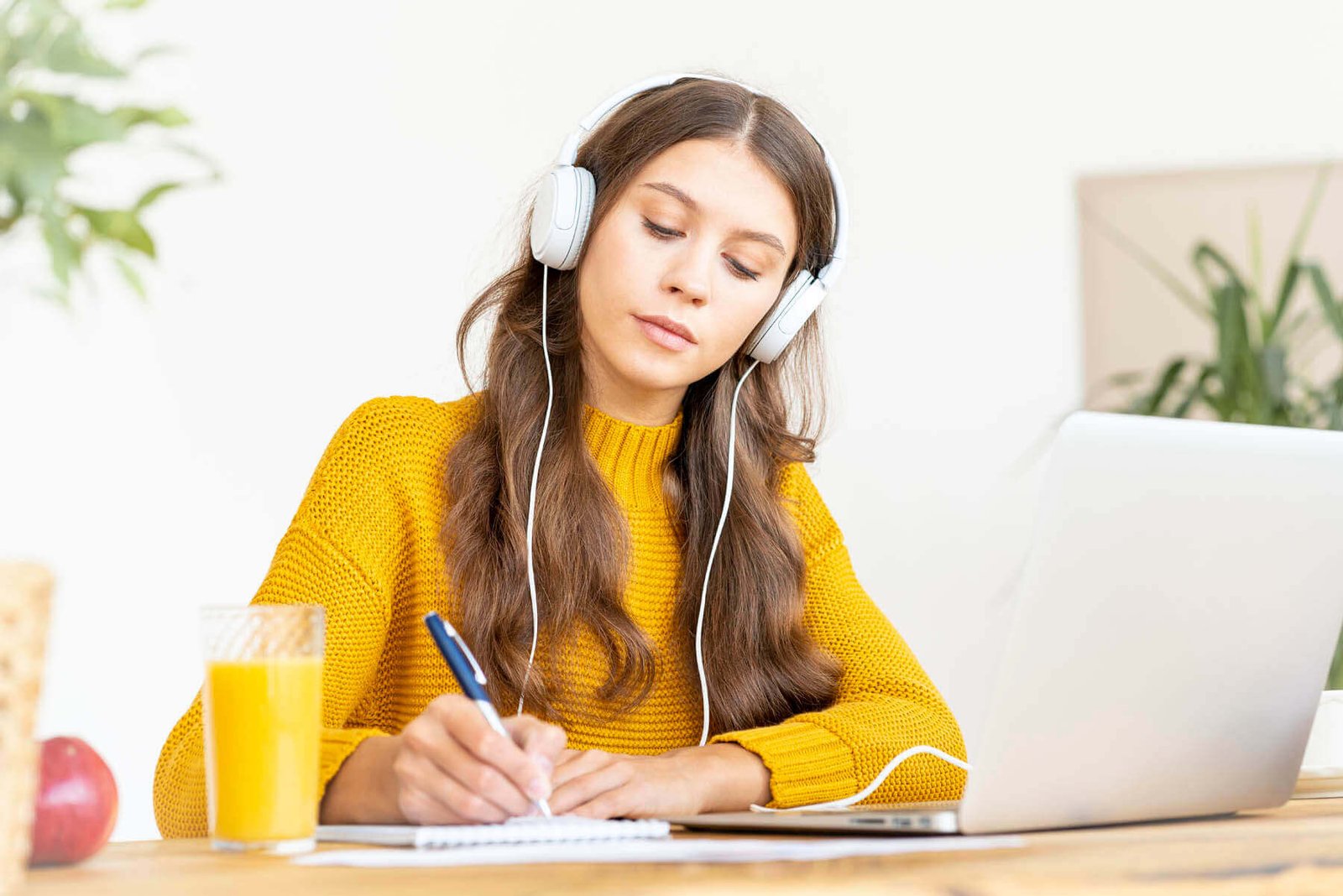 happy-female-in-wireless-headphones-studying-onlin-2021-08-29-15-15-41-utc.jpg